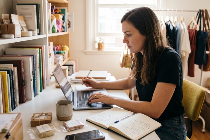 How to write product descriptions while a woman researches products and writes ecommerce copy on a laptop